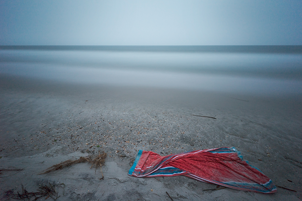 I took this at 7pm with darkness closing in. Someone's beach towel made for a nice complement to the bluish sky. 