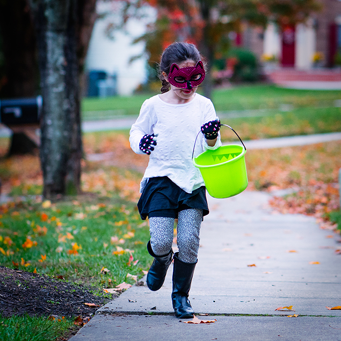 I knew she was going to run back to me. I went to manual focus and used the focus magnify feature (possible with mirrorless) to focus on the dark crack in the sidewalk. When she got to that point I "clicked." 85mm, f/2.0, 1/250, ISO1000.